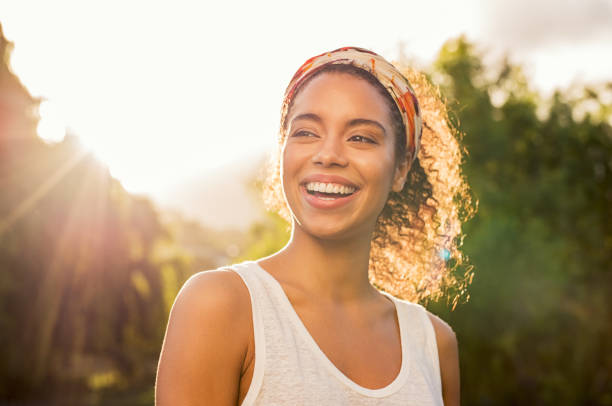 Woman smiling outdoors feeling healthy and energized